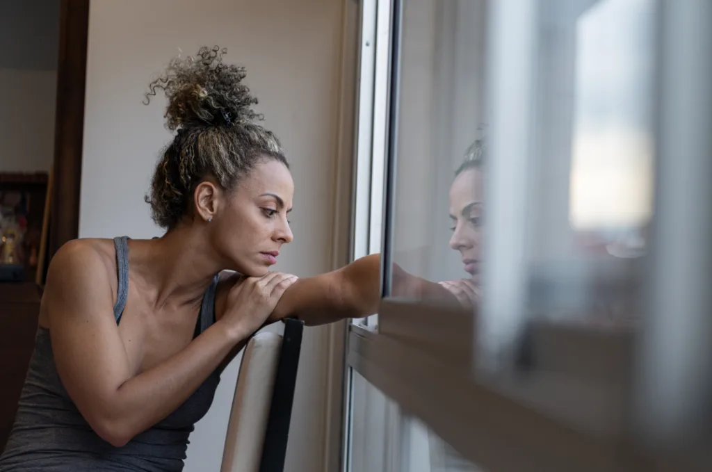 woman looking out window